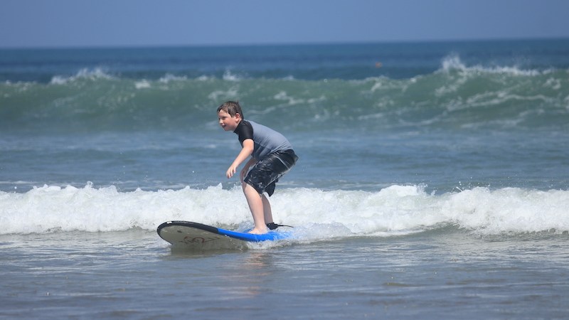 Boy learning to surf in Bali, Indonesia.