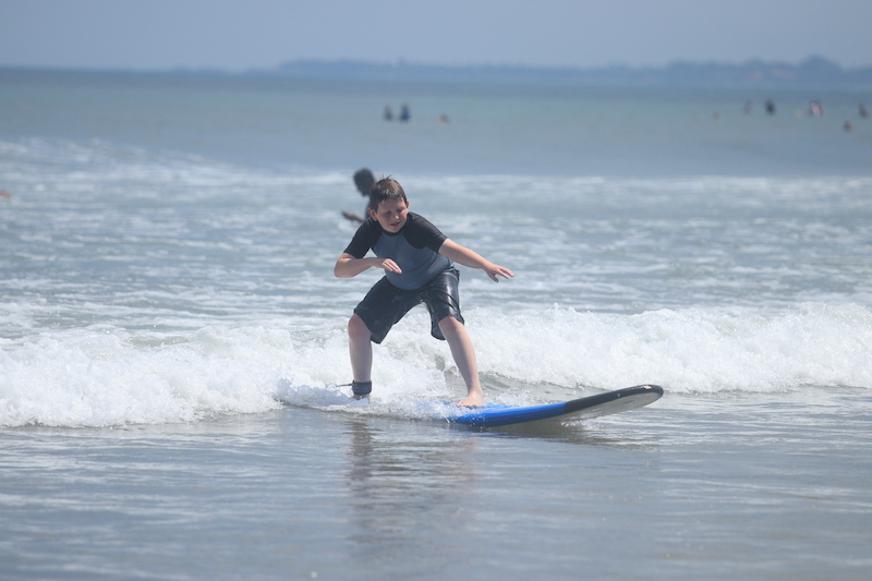 Boy learning to surf.
