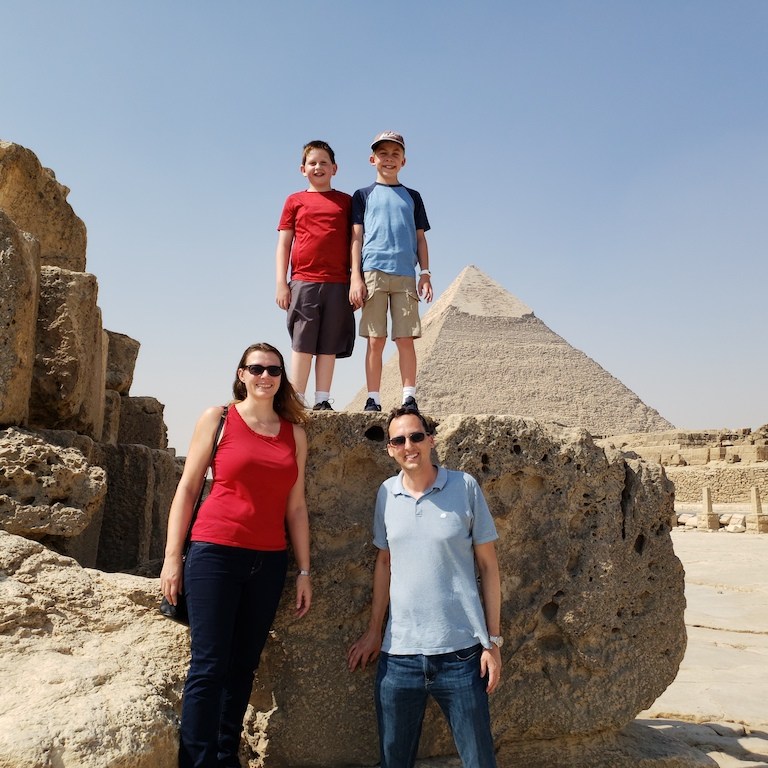Family enjoying exploring the Giza Pyramids near Cairo, Egypt.
