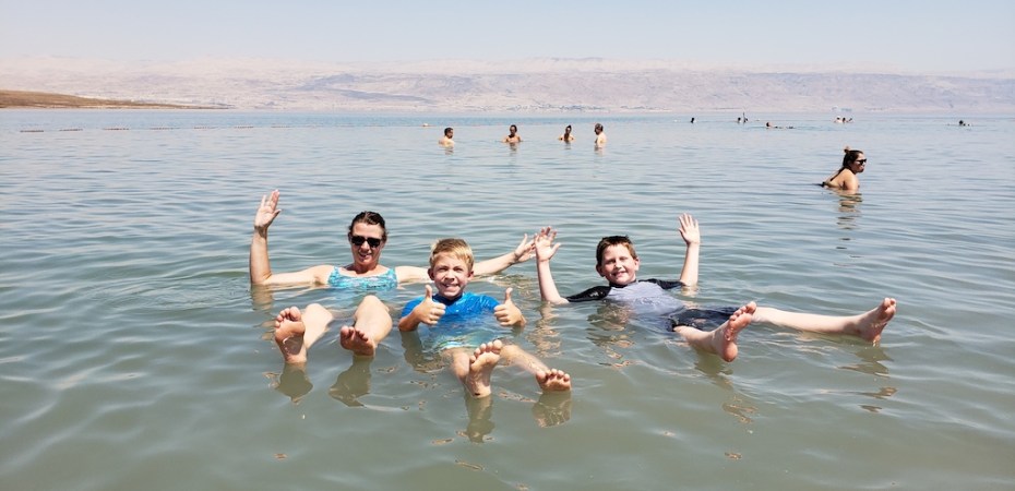 Mom and sons enjoying floating like corks in the Dead Sea in Israel.