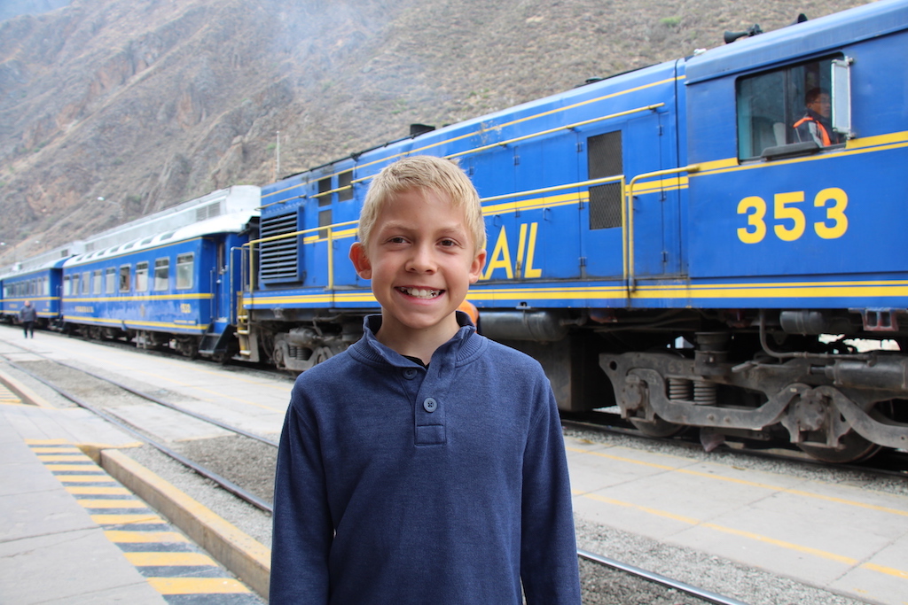 Boy in front of a train.