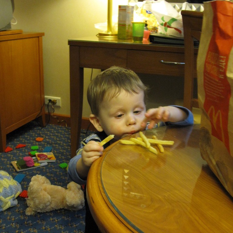 Boy playing in a hotel room.