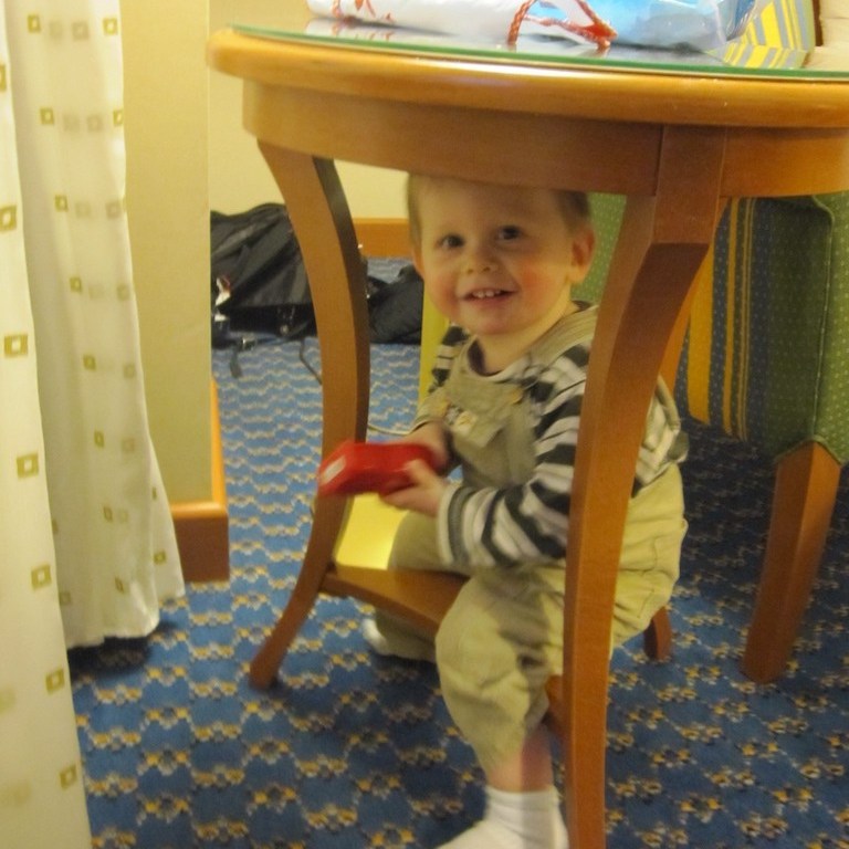 Boy playing in a hotel room.