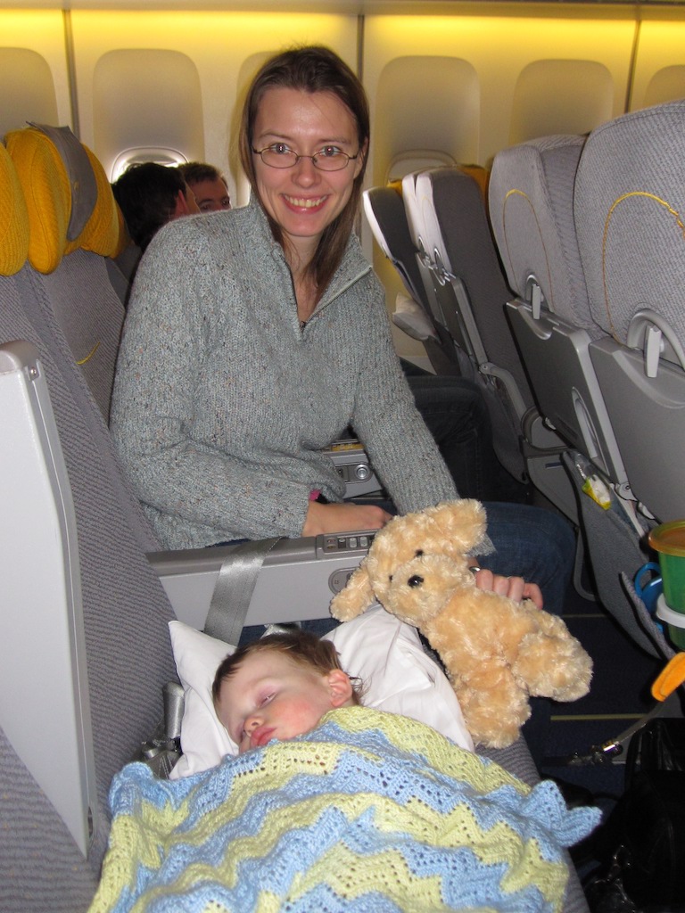 Boy sleeping on an airplane.