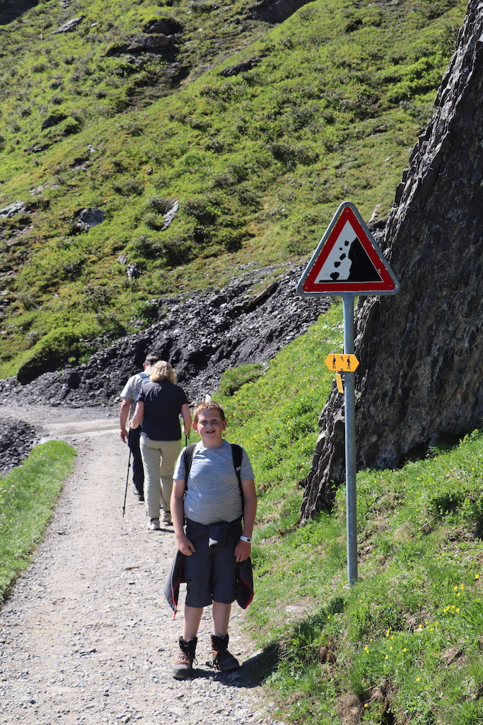 Falling rock sign while hiking the Panoramaweg from from Männlichen to Kleine Scheidegg in the Jungfrau Region of Switzerland.