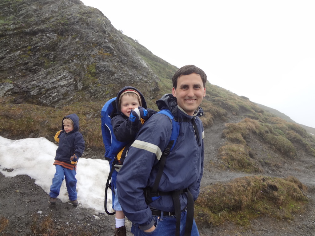 Dad and two boys hiking in the Jungfrau Region of Switzerland.