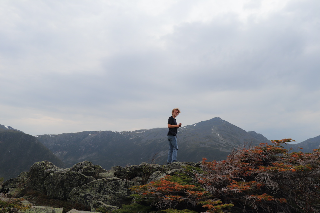 Teenage boy at the top of Mount Washington State Park in New Hampshire.