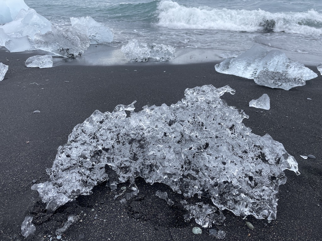 Block of ice on beach while driving from Vík to Seyðisfjörður in Iceland.