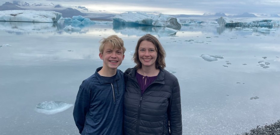 Mom and son standing by Jökulsárlón Glacier Lagoon in Iceland.